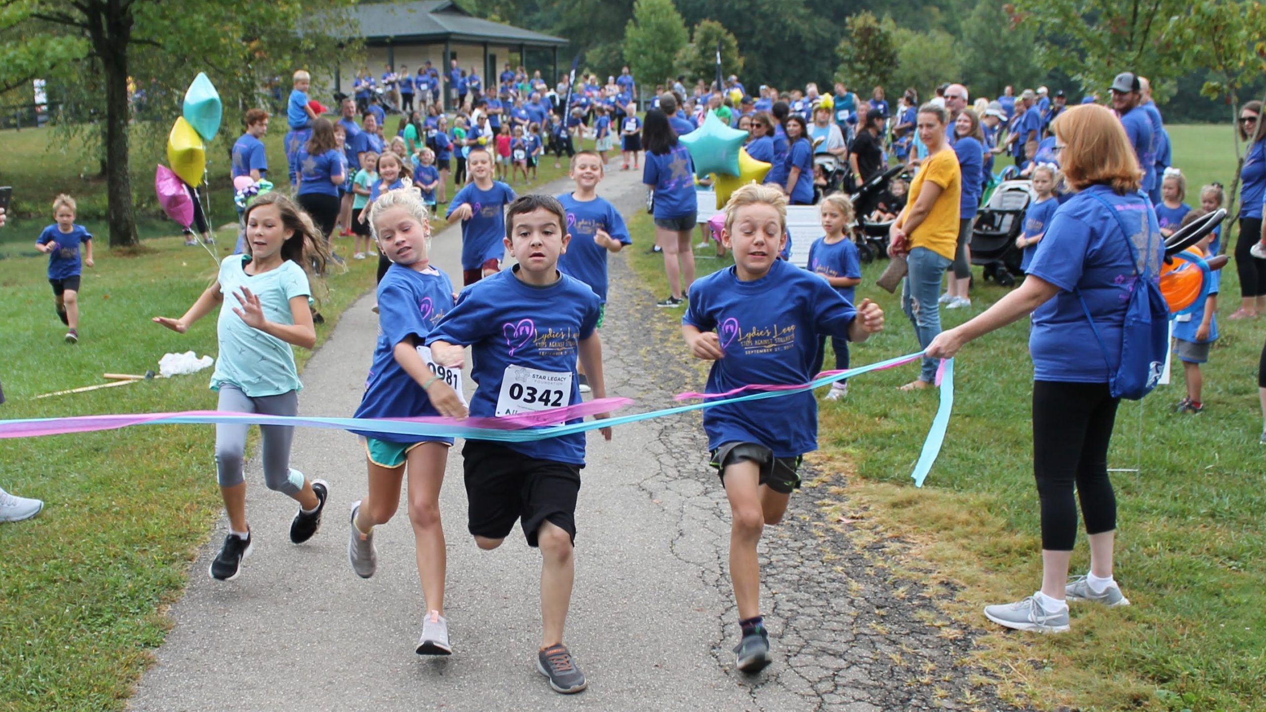 Kids cross the finish line at Lydie's Loop kids race