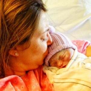 Count the Kicks Minnesota Ambassador Tausha Patterson kisses her daughter Amelia, who was born still in August 2019.