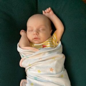 Baby save Tasman sleeps in a swaddle blanket