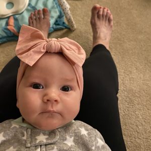 Baby Save Clementine wears a pink bow