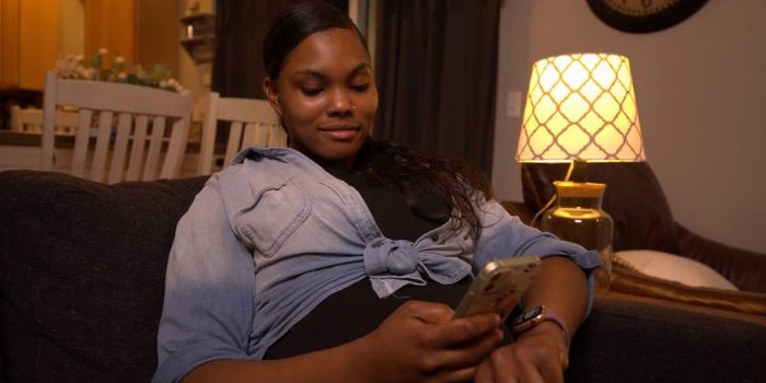 An expectant mom counts kicks on her phone using the free Count the Kicks app.