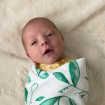Baby Save Lucy in a colorful swaddle blanket