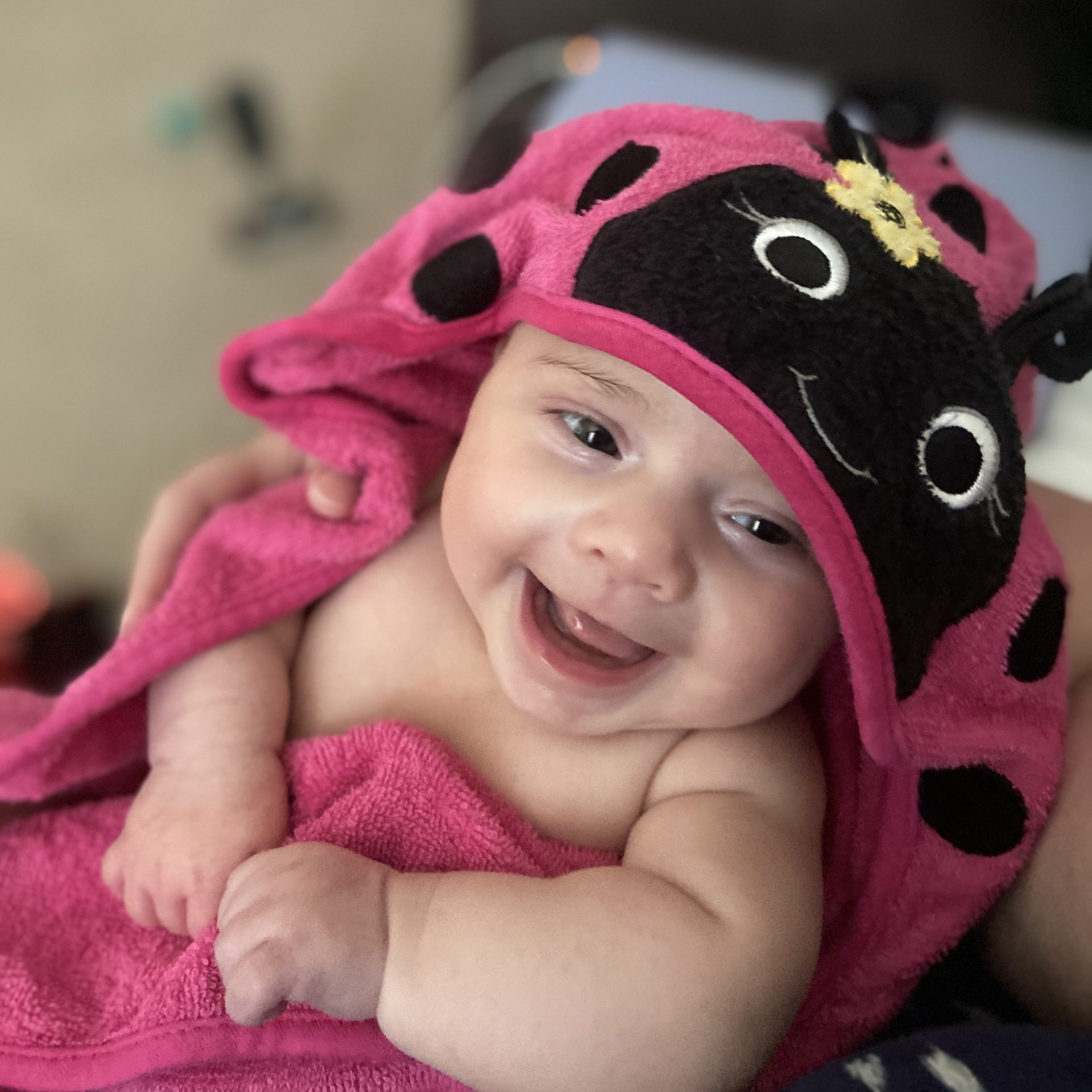 Baby save Daisy wears a ladybug towel.