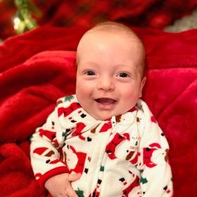 Baby Liam wearing a Santa sleeper