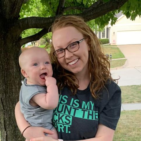 Baby save mom Olivia Gual, wearing a gray Count the Kicks shirt, holds her son Gus.