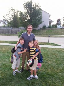 Luke Morlan stands with his three living children,