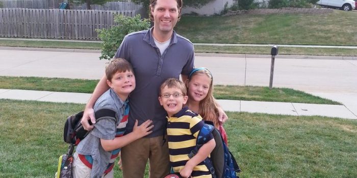 Luke Morlan stands with his three living children,