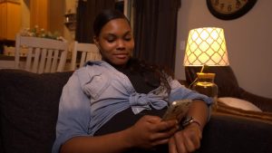 An expectant mom counts kicks on her phone using the free Count the Kicks app.