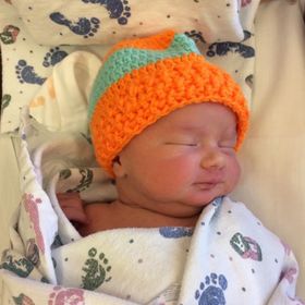 Baby Save Aiden wearing an orange hat.