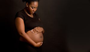 An expectant mom looks at her pregnant belly