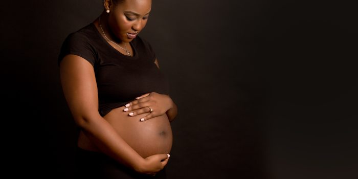 An expectant mom looks at her pregnant belly