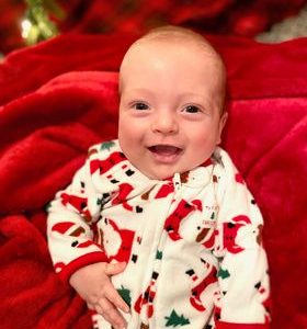 Baby Liam wearing a Santa sleeper