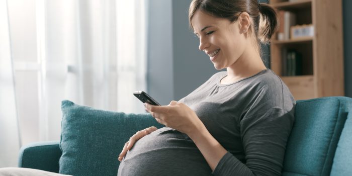 A pregnant woman using the Count the Kicks app to track her baby's movement.